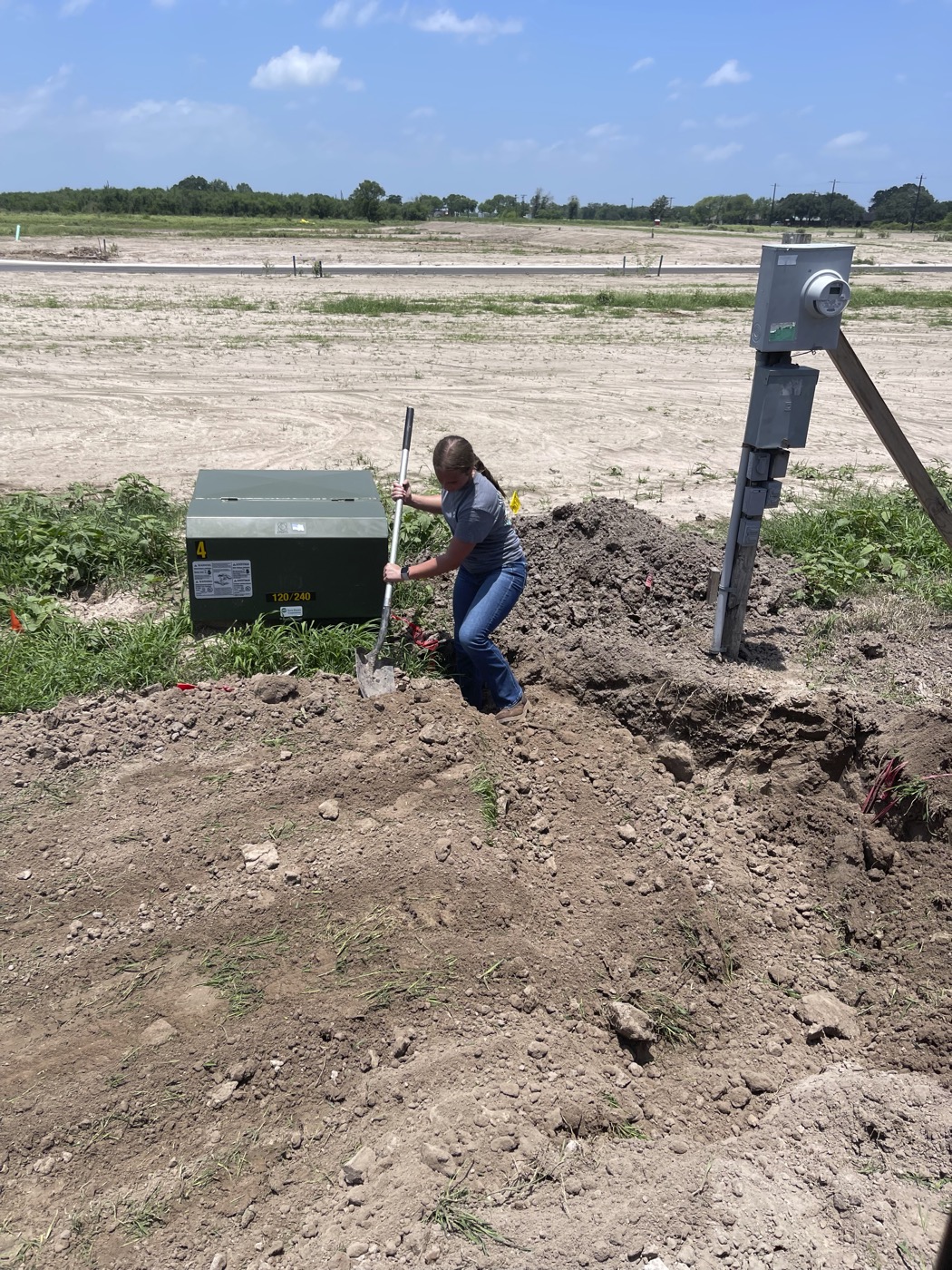 Kara Geigle installing an underground electric line at a Victoria, TX jobsite