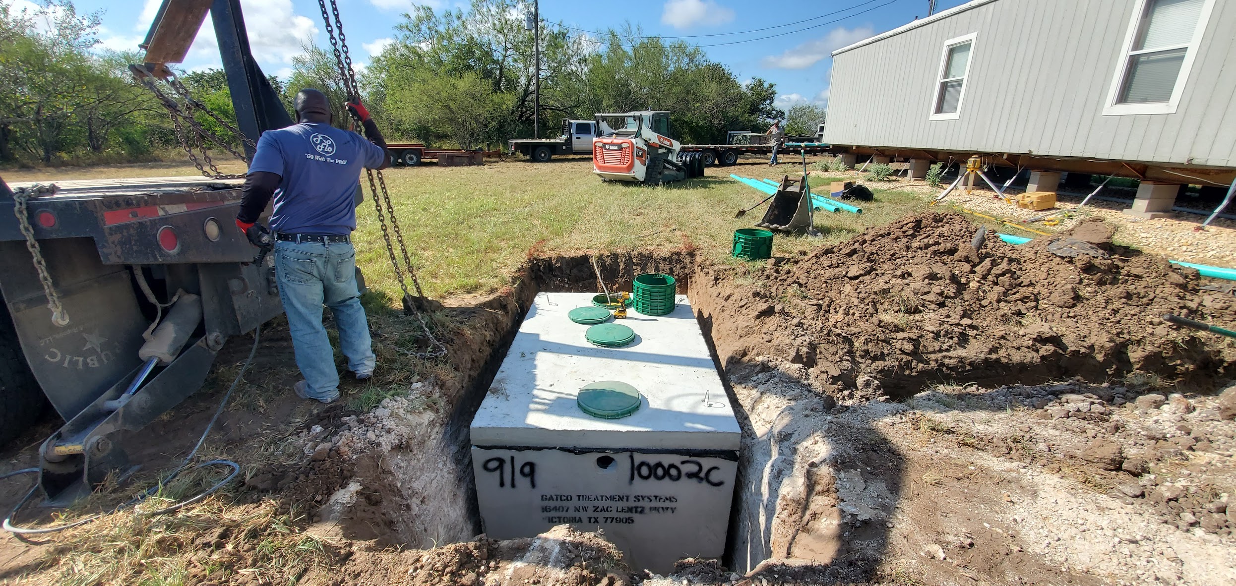 Septic tank being lowered into excavation in Victoria, TX